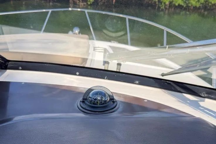 Sophia Yacht Photos Pics Dashboard view of 2015 Regal 38 Express boat with compass and windshield.