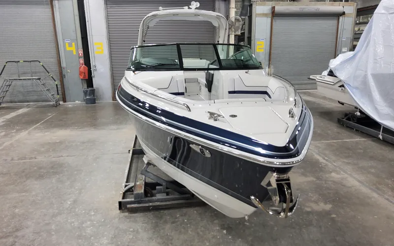  Yacht Photos Pics 2026 Formula 290 Bowrider boat in a warehouse, showcasing sleek design and modern features.