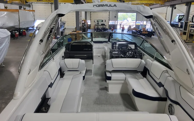  Yacht Photos Pics 2026 Formula 290 Bowrider interior, spacious seating, modern dashboard, in a boat workshop.