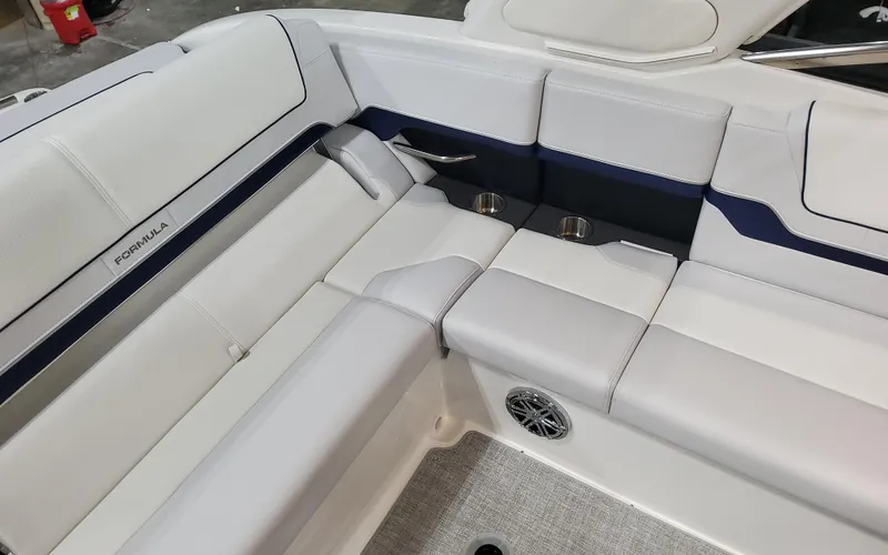  Yacht Photos Pics 2026 Formula 290 Bowrider interior with white and navy seating, cup holders, and speaker.