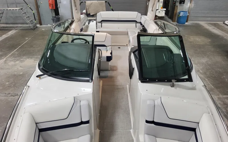  Yacht Photos Pics 2026 Formula 290 Bowrider boat interior with seating and windshield in a garage setting.
