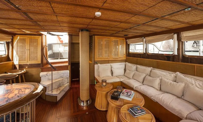 27 M Deluxe Gulet Yacht Photos Pics Luxurious interior of a 2003 Custom Made Motorsailor with elegant wood and wicker accents.