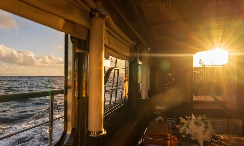 27 M Deluxe Gulet Yacht Photos Pics Sunset view from 2003 Custom Made Motorsailor, interior with ocean and floral arrangement.