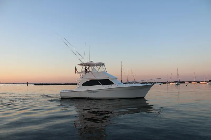 Baby Grand Yacht Photos Pics 2006 Egg Harbor 43 Sport Yacht on calm water at sunset.