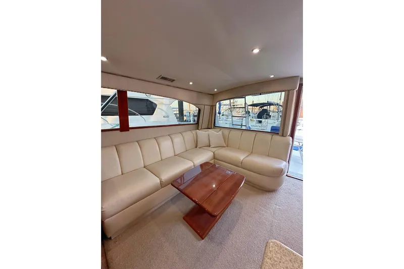 Baby Grand Yacht Photos Pics Luxurious interior of 2006 Egg Harbor 43 Sport Yacht with cream leather seating and wooden table.
