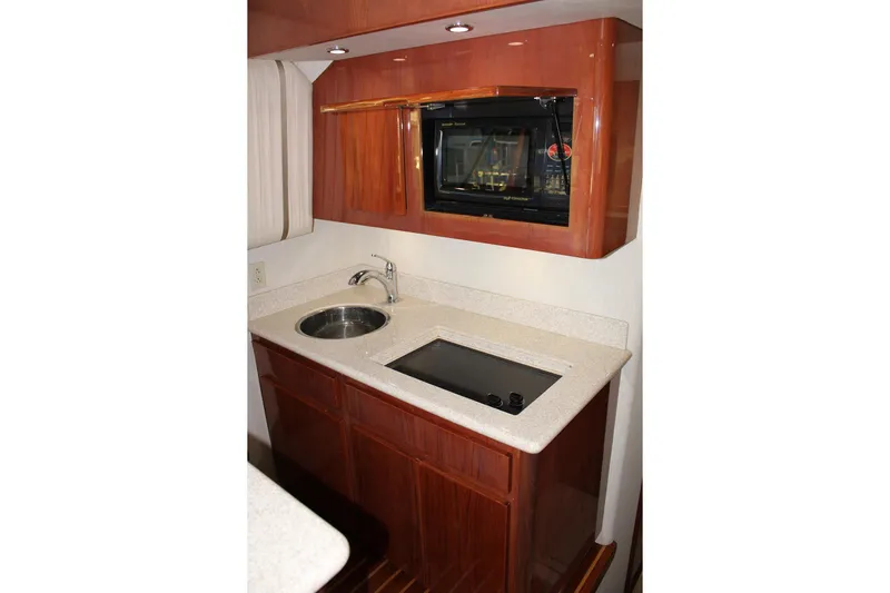 Baby Grand Yacht Photos Pics Luxurious kitchen area in a 2006 Egg Harbor 43 Sport Yacht with modern amenities.