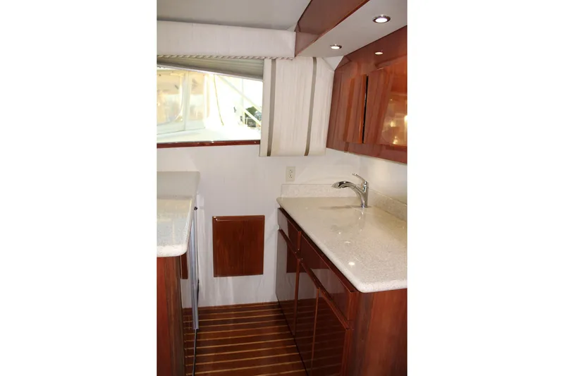 Baby Grand Yacht Photos Pics Interior of 2006 Egg Harbor 43 Sport Yacht with sleek wood cabinetry and modern fixtures.