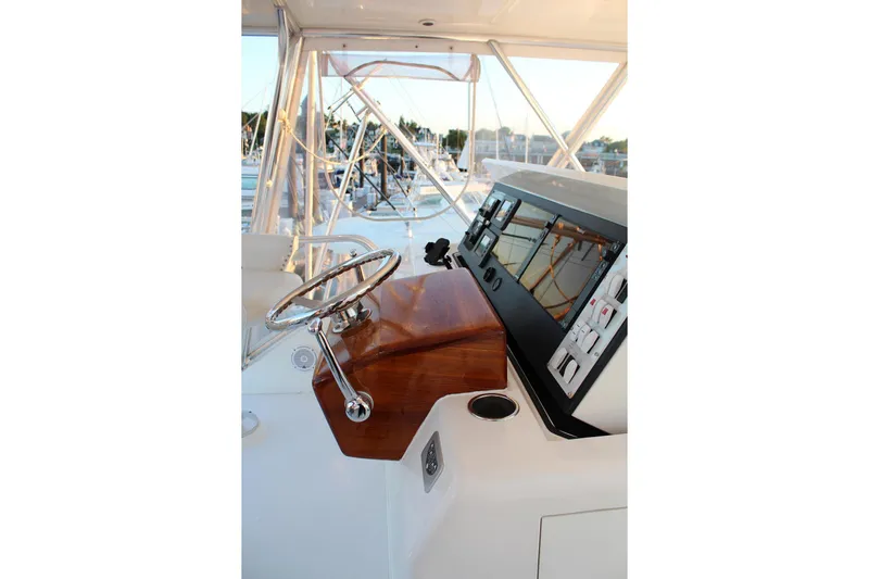 Baby Grand Yacht Photos Pics Helm of 2006 Egg Harbor 43 Sport Yacht with polished wood and modern controls.