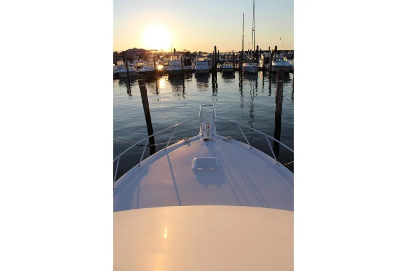 Baby Grand Yacht Photos Pics Bow view of 2006 Egg Harbor 43 Sport Yacht at sunset in marina.