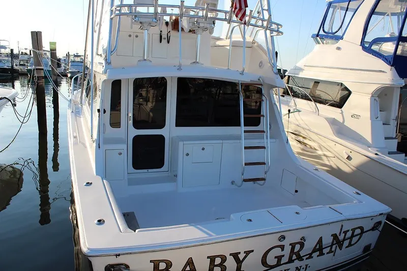 Baby Grand Yacht Photos Pics 2006 Egg Harbor 43 Sport Yacht docked, showcasing spacious deck and ladder.