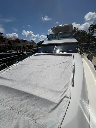  Yacht Photos Pics 2018 Prestige 680 yacht docked under a clear blue sky, showcasing sleek design and luxury features.