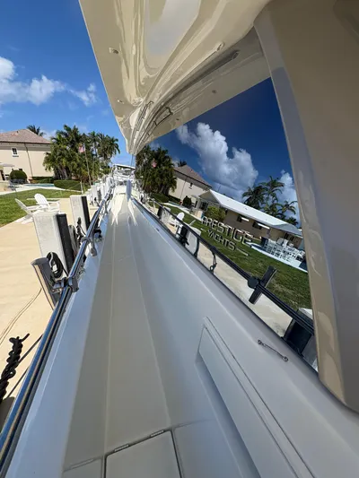  Yacht Photos Pics 2018 Prestige 680 yacht docked, reflecting clear blue sky and palm trees.