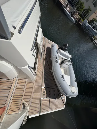  Yacht Photos Pics Prestige 680 yacht with inflatable boat on deck, docked in marina, 2018 model.