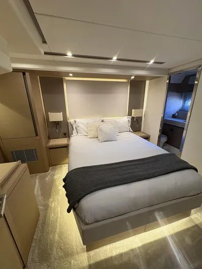  Yacht Photos Pics Luxurious bedroom interior of 2018 Prestige 680 yacht with modern design and ambient lighting.