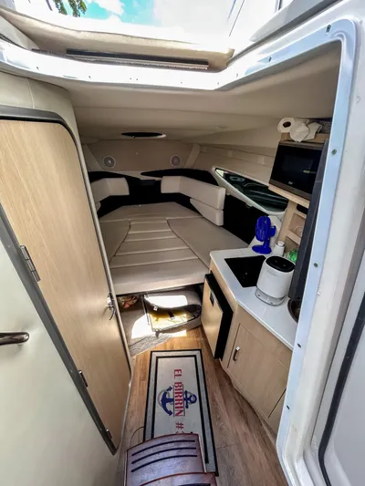  Yacht Photos Pics Interior of 2023 Regal 26 XO boat, featuring cozy cabin and kitchenette.
