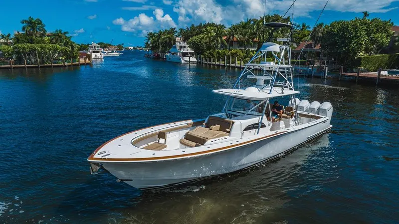  Yacht Photos Pics 2023 Valhalla Boatworks V-46 cruising on a scenic waterway under a clear blue sky.