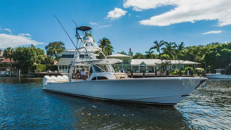  Yacht Photos Pics 2023 Valhalla Boatworks V-46 yacht cruising on a sunny day near waterfront homes.