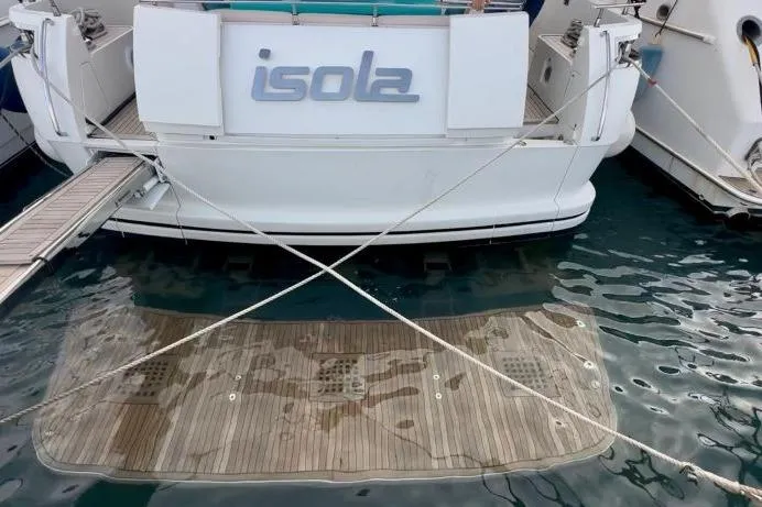  Yacht Photos Pics Sanlorenzo 62 yacht, 2008 model, docked with visible swim platform and "isola" nameplate.