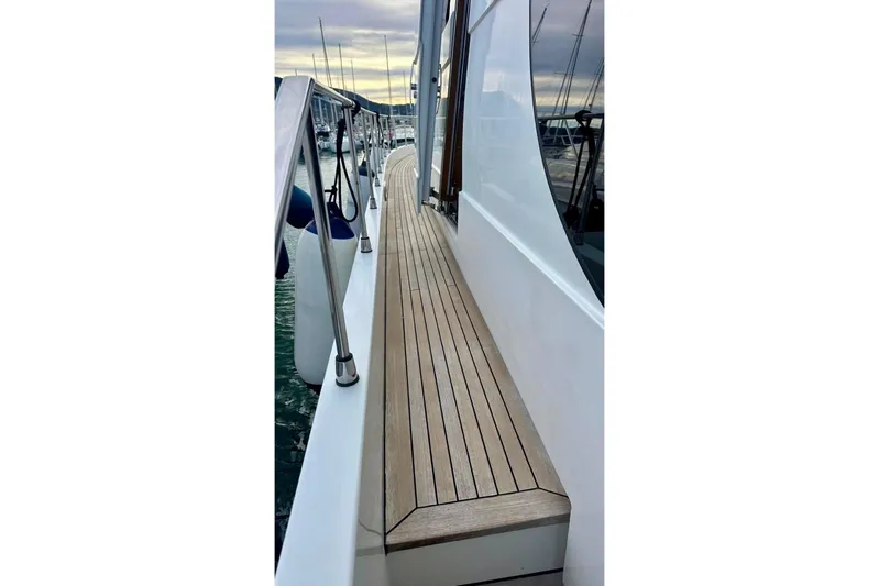  Yacht Photos Pics Side deck of 2008 Sanlorenzo 62 yacht with wooden flooring and railing.