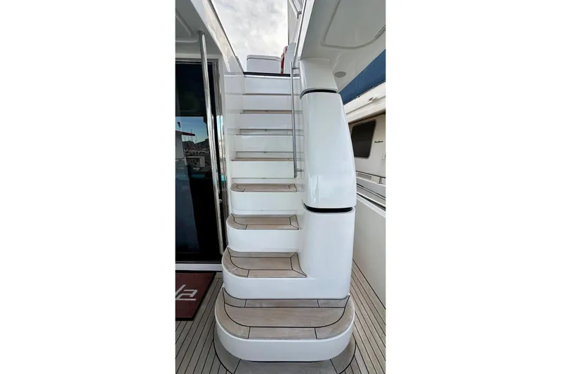  Yacht Photos Pics Staircase on 2008 Sanlorenzo 62 yacht with sleek white design and wooden steps.