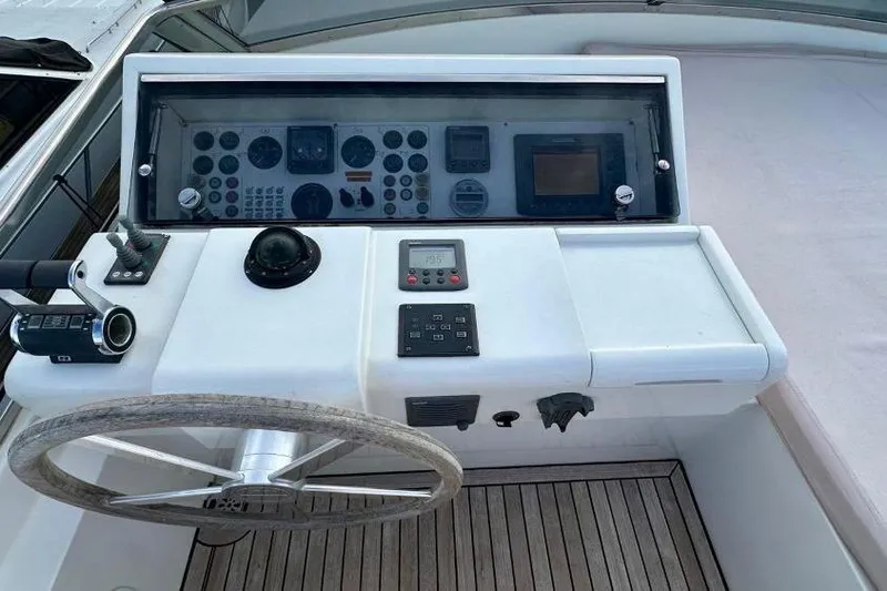  Yacht Photos Pics Control panel of a 2008 Sanlorenzo 62 yacht with steering wheel and navigation instruments.
