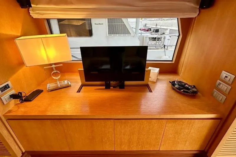  Yacht Photos Pics Luxurious interior of 2008 Sanlorenzo 62 yacht with TV, lamp, and window view.