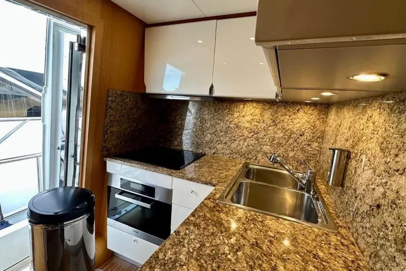  Yacht Photos Pics Luxurious kitchen interior of 2008 Sanlorenzo 62 yacht with granite countertops and modern appliances.