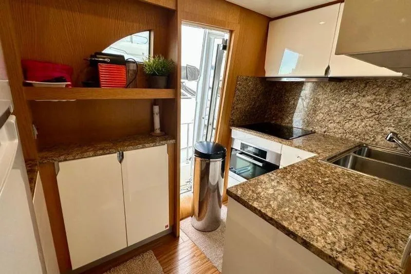  Yacht Photos Pics Luxurious kitchen interior of 2008 Sanlorenzo 62 yacht with granite countertops.