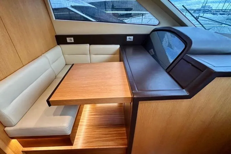  Yacht Photos Pics Luxurious interior of 2008 Sanlorenzo 62 yacht with elegant seating and wooden table.