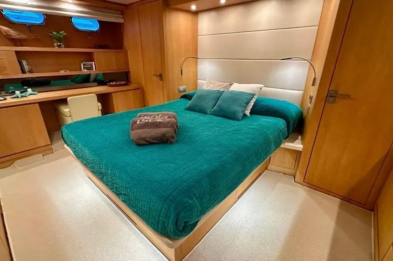  Yacht Photos Pics Luxurious Sanlorenzo 62 yacht bedroom, 2008 model, with teal bedding and wooden interior.