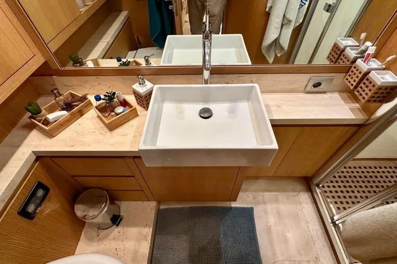  Yacht Photos Pics Luxurious bathroom in 2008 Sanlorenzo 62 yacht with modern sink and wooden accents.