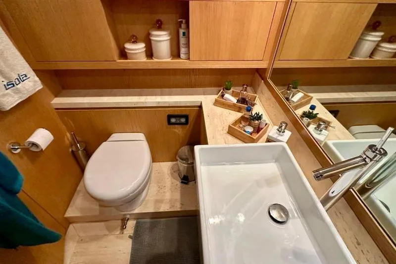  Yacht Photos Pics Luxurious bathroom in 2008 Sanlorenzo 62 yacht with modern fixtures and elegant wood accents.