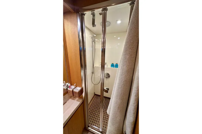  Yacht Photos Pics Luxurious bathroom shower in 2008 Sanlorenzo 62 yacht, featuring modern fixtures and wooden accents.