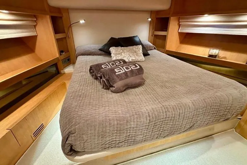  Yacht Photos Pics Luxurious bedroom interior of 2008 Sanlorenzo 62 yacht with cozy bedding and ambient lighting.