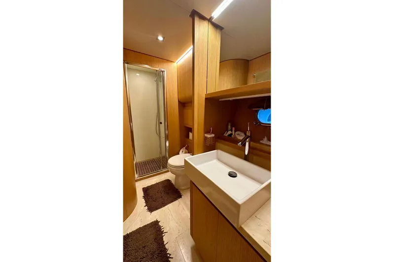  Yacht Photos Pics Luxurious bathroom in 2008 Sanlorenzo 62 yacht with modern fixtures and wooden accents.