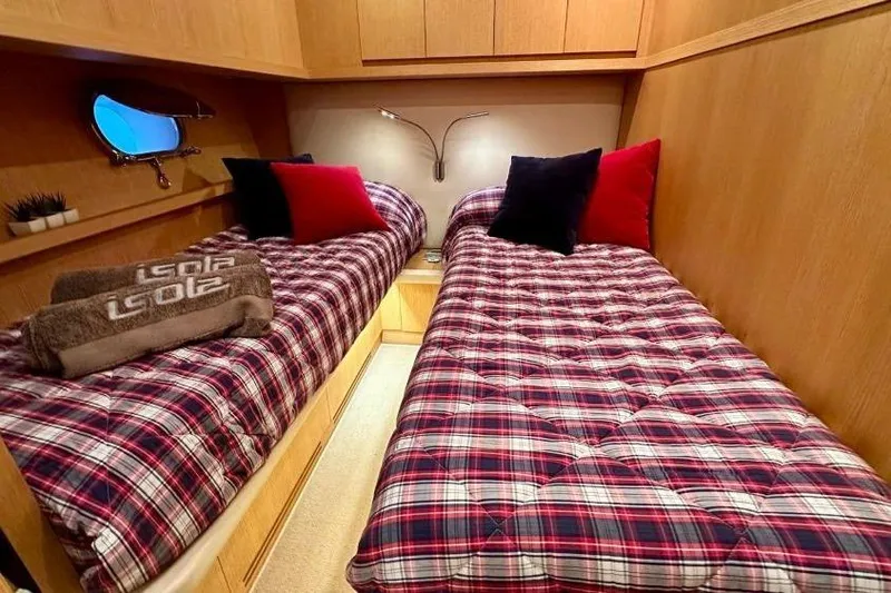  Yacht Photos Pics Twin cabin with plaid bedding in 2008 Sanlorenzo 62 yacht, featuring cozy decor and ambient lighting.