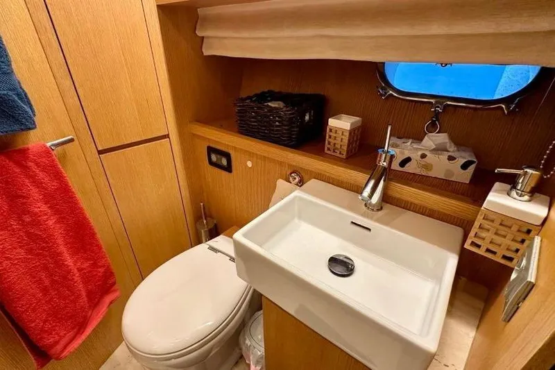  Yacht Photos Pics Luxurious bathroom in 2008 Sanlorenzo 62 yacht with modern fixtures and wooden accents.