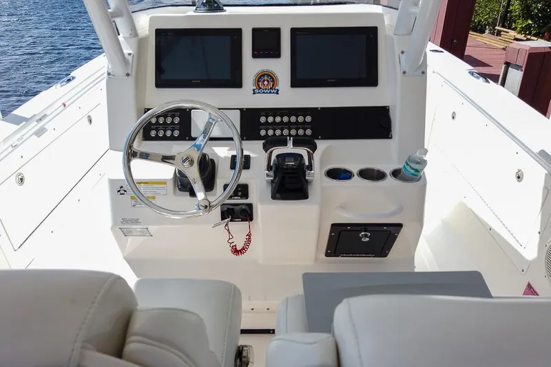  Yacht Photos Pics Cockpit of 2015 Edgewater 320CC boat with steering wheel and control panel.