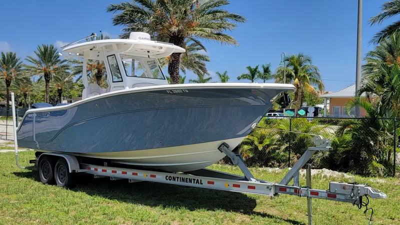  Yacht Photos Pics 2024 Sea Fox 288 Commander boat on trailer, surrounded by palm trees.
