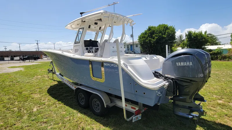  Yacht Photos Pics 2024 Sea Fox 288 Commander boat with Yamaha engine on a trailer, parked on grass.