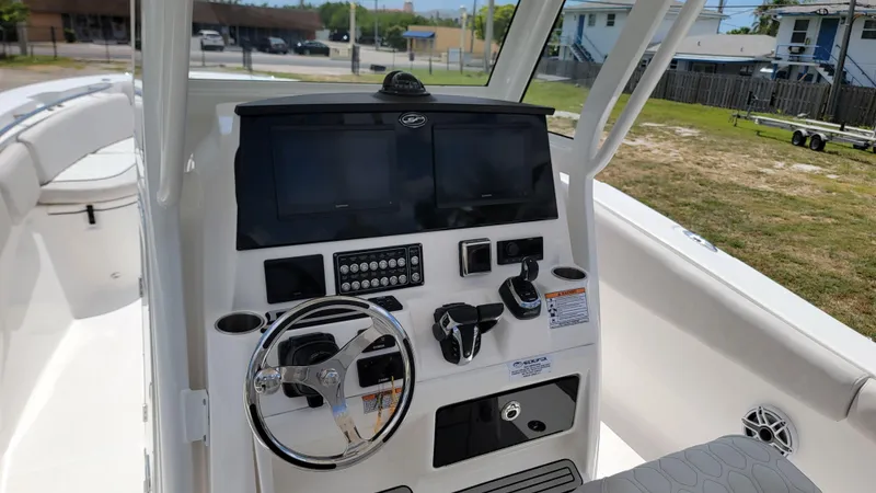  Yacht Photos Pics 2024 Sea Fox 288 Commander boat dashboard with steering wheel and electronic controls.