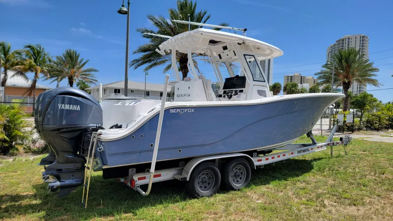  Yacht Photos Pics 2024 Sea Fox 288 Commander boat on trailer with Yamaha engine, parked outdoors.