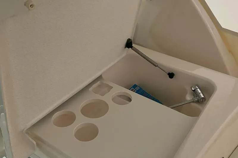  Yacht Photos Pics 2005 Tiara Yachts 3600 Sovran storage compartment with cup holders and hydraulic lift.