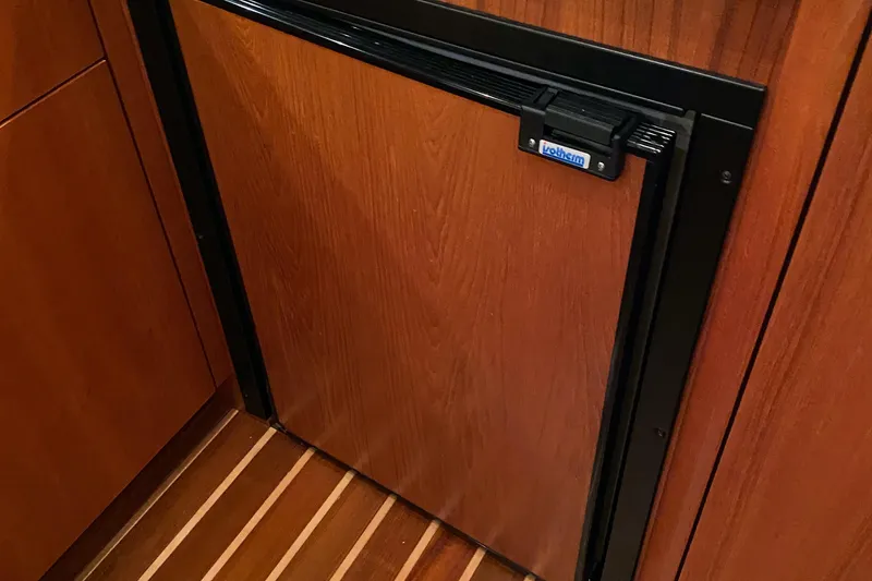  Yacht Photos Pics Wood-paneled refrigerator in 2005 Tiara Yachts 3600 Sovran, featuring elegant interior design.