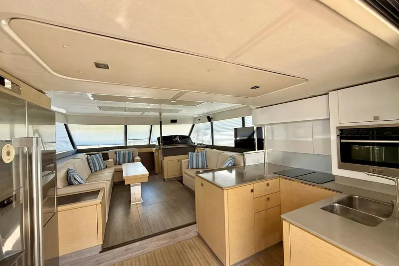  Yacht Photos Pics Luxurious interior of 2020 Fountaine Pajot MY 44 yacht with modern kitchen and seating area.
