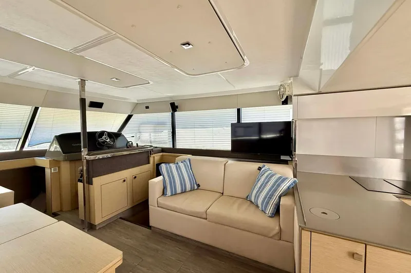  Yacht Photos Pics Luxurious interior of 2020 Fountaine Pajot MY 44 yacht with modern furnishings and helm station.