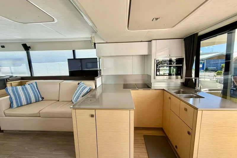  Yacht Photos Pics Modern interior of 2020 Fountaine Pajot MY 44 yacht with kitchen and seating area.