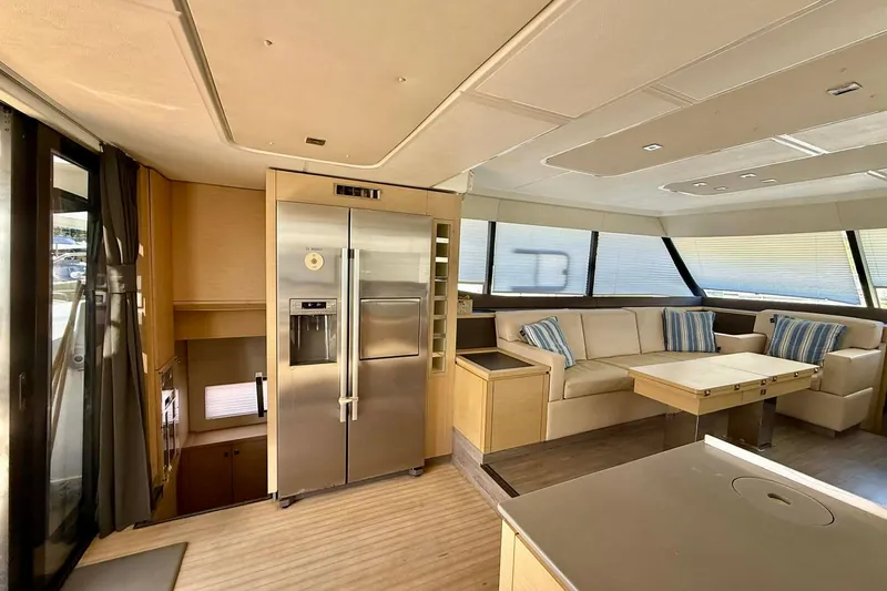  Yacht Photos Pics Luxurious interior of 2020 Fountaine Pajot MY 44 yacht with modern kitchen and seating area.