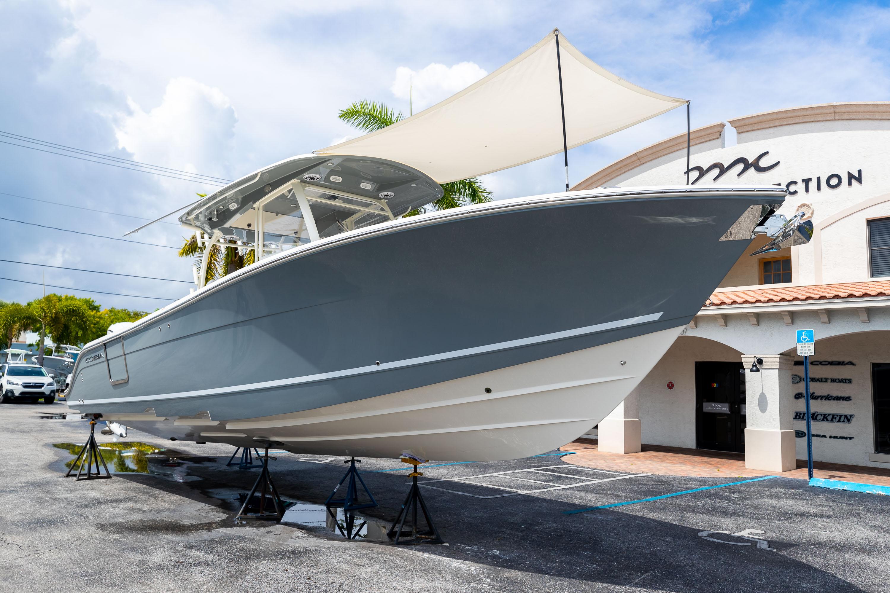 2023 Cobia 350 Center Console boat displayed outdoors on stands.