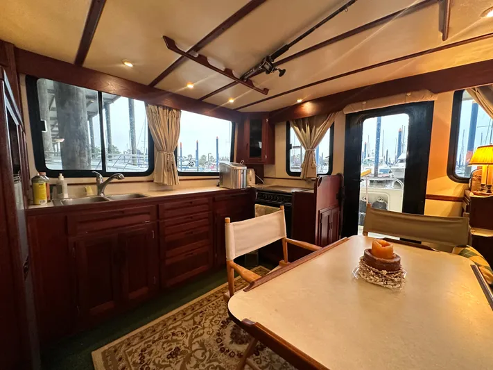 Ms. Moneypenny Yacht Photos Pics Interior of a 2001 Nordic Tug 37, featuring a cozy dining area and kitchenette.